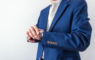businessman looking at classic wristwatch,diary page background, time management concept photo