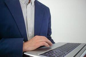 Business man hands typing on laptop computer keyboard, surfing the internet at the office with copy space for web banner, IT worker and business concept photo
