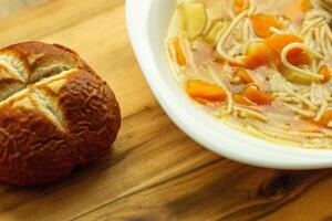 vegetable soup with carrots and potatoes, Bavarian bun photo