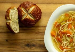 vegetable soup with carrots and potatoes, Bavarian bun photo