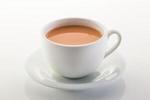 Hot milk tea ir chai served in cup isolated on grey background side view of chinese hot drink photo