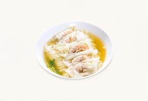 Shrimp and Pork Wonton dumplings Noodle Soup served in bowl isolated on grey background side view of hong kong food photo