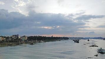Beautiful scenery of colorful clouds reflecting in the river during sunset photo