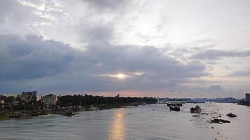 Beautiful scenery of colorful clouds reflecting in the river during sunset photo