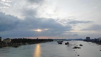 Beautiful scenery of colorful clouds reflecting in the river during sunset photo