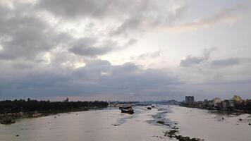 Beautiful scenery of colorful clouds reflecting in the river during sunset photo