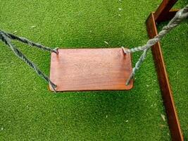 a wooden swing stand in a playground photo