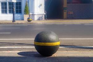 a bollard or safety guard to protect pedestrians on the sidewalk so they can walk safely photo