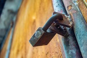 a rusty iron padlock that is very strong and locked for security photo