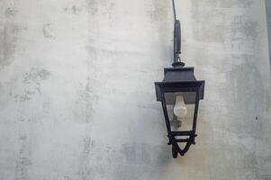 Medieval wall with a lamp in Surabaya old city area with white wall copy space photo