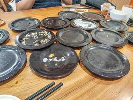 many leftover plates of sushi food in Japanese restaurants. hygiene and health content. photo