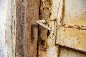 an old wooden door handle that was locked photo