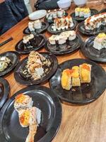 one large table contains many sushi plates in a Japanese restaurant photo