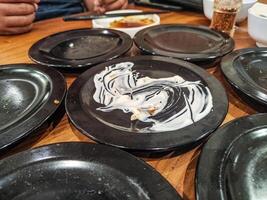many leftover plates of sushi food in Japanese restaurants. hygiene and health content. photo