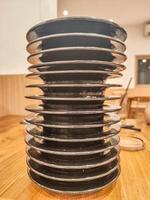 pile of plates of leftover sushi food in a Japanese restaurant with an all you can eat or buffet concept and Kaitenzushi or moving conveyor sushi. photo