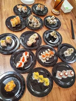 one large table contains many sushi plates in a Japanese restaurant photo