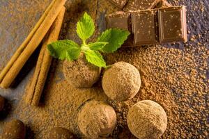 Chocolate truffle. Chocolate sweets on the table with mint and vanilla on the table photo