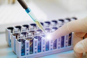 Rack of tube in laboratory with biological material in laboratory at the table. Closeup. photo
