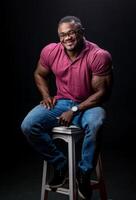 Attractive mucular man posing on dark background. Stylish male model in lifestyle cloth. photo