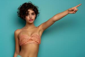 Woman in Coral Lace Top Pointing Enthusiastically, Capturing Modern Fashion and Vibrant Style in Studio Setting photo