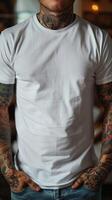 Tattooed Man in White T-Shirt Standing with Hands in Pockets photo