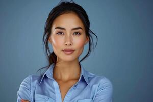Professional Businesswoman Confident Expression Arms Crossed Blue Background Studio Portrait photo