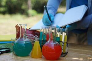 Colorful chemical substances in glass test tubes and equipment for studying. Concept, science experiment, Chemistry lesson. Learning by doing. Observe and analyze test result. photo
