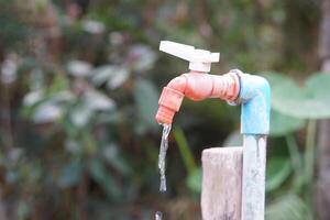 Old water faucet with dripping. Concept. Save water for environment. Turn off tap or faucet before leaving. Don't waste water by let it dripping or leaking. photo