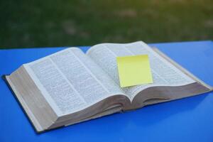 Opened page, dictionary, book with blank yellow paper for adding text or word. Concept, education. photo