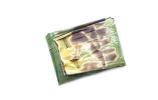 Food wrapped in toast banana leaf in rectangle shape, isolated on white background. Concept, using natural material that can be degraded to be packaging of food for safety. Traditional food, Cooking. photo