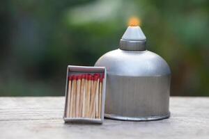 Stainless steel alcohol burner lantern. Laboratory lamp and box of matches. Concept, equipment or tool for science experiment. Educational toolkit in science subject. photo