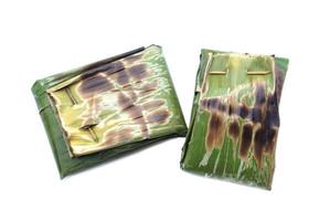 Food wrapped in toast banana leaf in rectangle shape, isolated on white background. Concept, using natural material that can be degraded to be packaging of food for safety. Traditional food, Cooking. photo