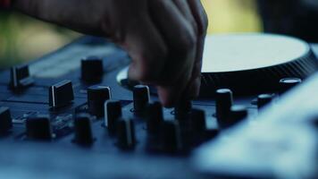 Close-up view of a hand of a musician who carefully adjusting the knob on the sound mixing console during a music recording session in the studio video