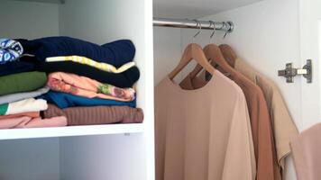 Neatly Organized Closet with Folded Clothes and Hanging Garments in a Clean and Tidy Room video