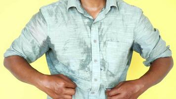 A detailed view of a man with sweat marks showcasing the impact of intense humidity video