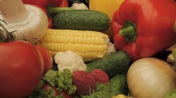 This showcases a variety of fresh vegetables and fruits, including red bell peppers, cucumbers, corn on the cob, cauliflower, mushrooms, tomatoes, onions, and raspberries. video