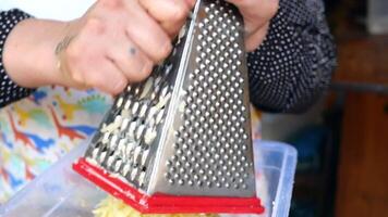 Grating cheese by hand in the kitchen can be considered an artisanal culinary practice video