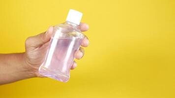 hand hold a mouthwash liquid container . video