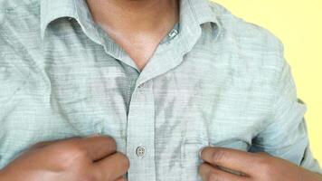 A detailed view of a man with sweat marks showcasing the impact of intense humidity video