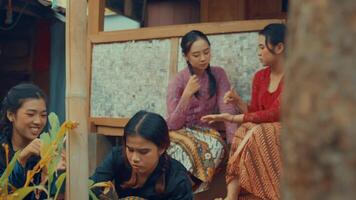 Women in traditional attire conversing in a rustic setting video