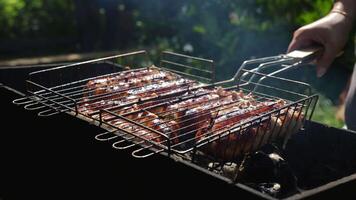 Juicy sausages spilling out of a grill after an unsuccessful flip, showcasing the unpredictable nature of alfresco cooking video