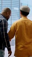 Vertical Real estate agent showcasing modern office blueprints to clients, discussing the architectural design and their vision to change the space for relocation. High class urban rental agreement. Camera A. video
