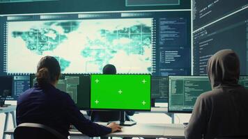 Governmental hackers using green screen in performing cyber security monitoring and threat detection. Examining network security and protection against cyber attacks, national intelligence. Camera B. video