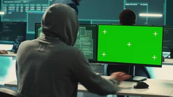 Governmental hackers working on computer with green screen to protect data and network security. Focusing on cyber defense, malware detection to prevent cyber attacks and espionage. Camera A. video