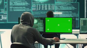 Professional team of governmental hackers conducting cyber surveillance, looks at isolated copy space screen. Expert examines cybersecurity measures and online security in high tech agency. Camera A. video