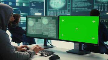 Professional team of governmental hackers conducting cyber surveillance, looks at isolated copy space screen. Expert examines cybersecurity measures and online security in high tech agency. Camera B. video