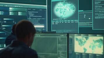 Military hackers working on cyber security in a high tech government center. Focusing on network protection, encryption and preventing cyber attacks to safeguard state secrets. Camera A. video
