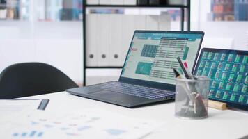 Stock market values going up and down on laptop in empty financial department office, price volatility concept. Forex trading economic analytics figures on notebook screen in workspace video