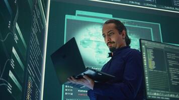 Governmental hacker expert working on securing digital information, analyzes intelligence on big screen. Specialist works to prevent cyber threats with advanced technology, cyberterrorism. Camera B. video
