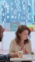 Vertical Realtor and clients exploring an urban property financial potential, evaluating architectural blueprints and negotiating leasing contract terms for a high class corporate office space. Camera B. video
